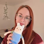Annalisa, the designer behind InaCozyCrafts, holding a crochet bunny